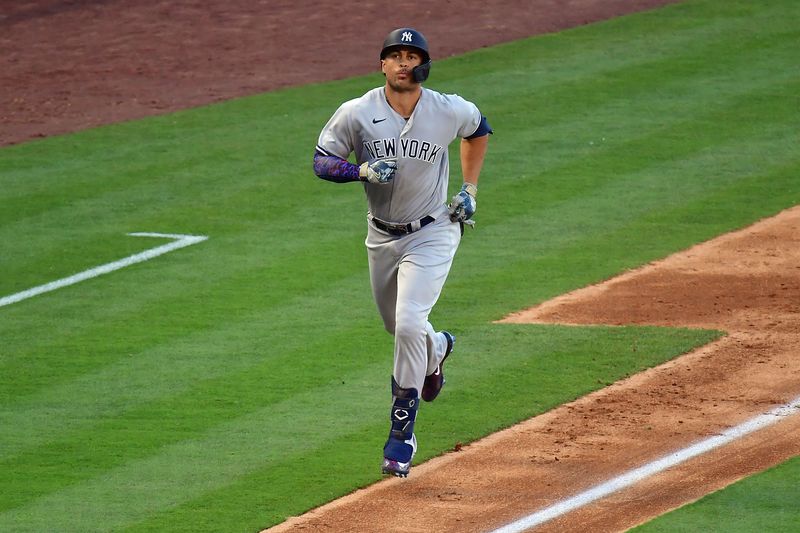 Jul 19, 2023; Anaheim, California, USA; New York Yankees designated hitter Giancarlo Stanton (27) runs home after hitting a solo home run against the Los Angeles Angels during the sixth inning at Angel Stadium. Mandatory Credit: Gary A. Vasquez-USA TODAY Sports