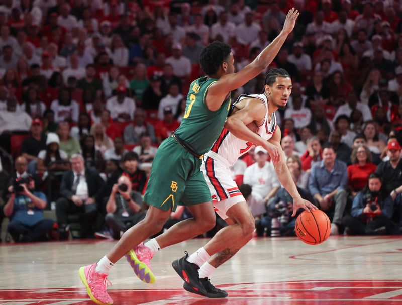 Feb 10, 2025; Houston, Texas, USA;  Houston Cougars guard Milos Uzan (7) dribbles against Baylor Bears guard Jeremy Roach (3) in the first half at Fertitta Center. Mandatory Credit: Thomas Shea-Imagn Images