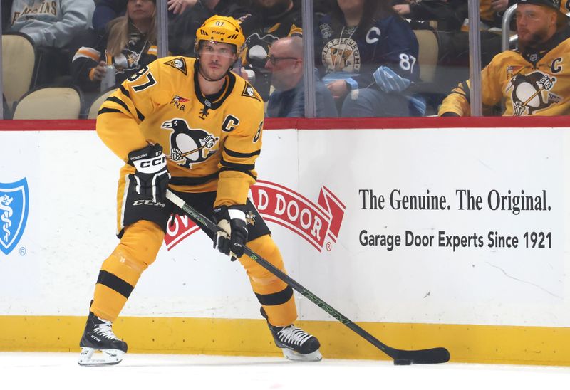 Oct 9, 2025; Pittsburgh, Pennsylvania, USA;  Pittsburgh Penguins center Sidney Crosby (87) moves the puck against the New York Islanders during the second period at PPG Paints Arena. Mandatory Credit: Charles LeClaire-Imagn Images