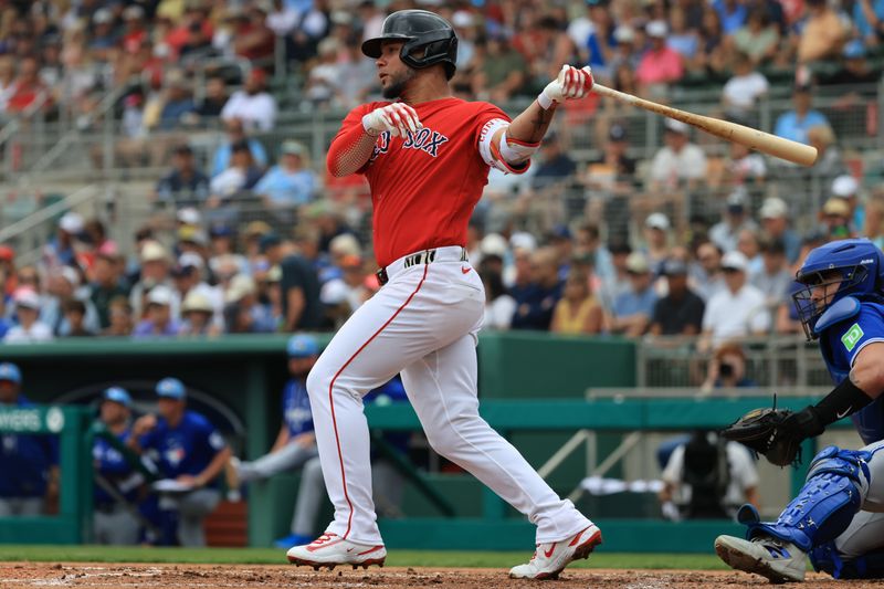 Feb 22, 2026; Fort Myers, Florida, USA; Boston Red Sox first baseman Willson Contreras (40) hits a sacrifice RBI during the first inning against the Toronto Blue Jays  at JetBlue Park at Fenway South. Mandatory Credit: Kim Klement Neitzel-Imagn Images