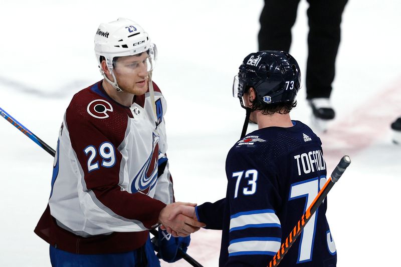 Apr 30, 2024; Winnipeg, Manitoba, CAN; Winnipeg Jets center Tyler Toffoli (73) congratulates Colorado Avalanche center Nathan MacKinnon (29) in game five of the first round of the 2024 Stanley Cup Playoffs at Canada Life Centre. Mandatory Credit: James Carey Lauder-USA TODAY Sports