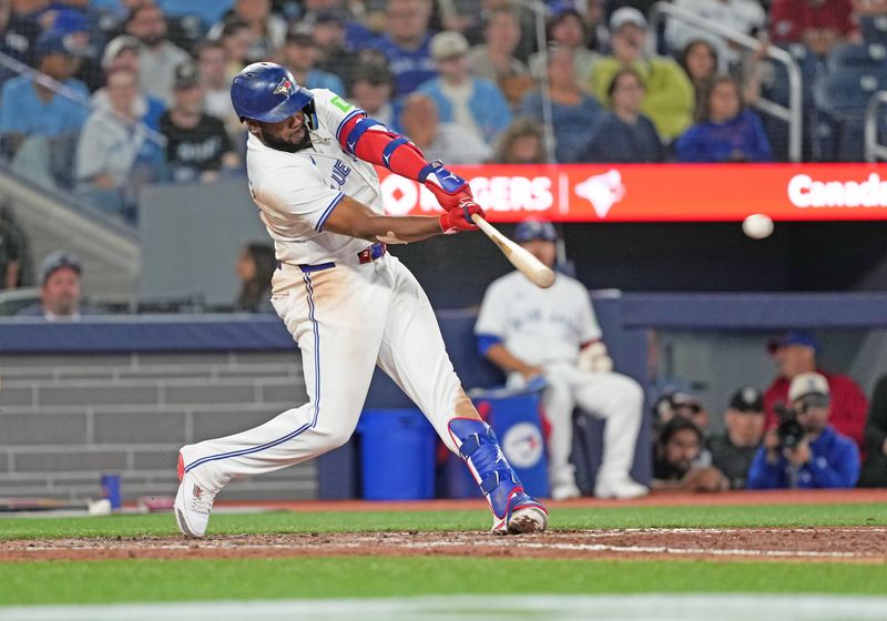 Sep 3, 2024; Toronto, Ontario, CAN; Toronto Blue Jays first baseman Vladimir Guerrero Jr. (27) hits a double against the Philadelphia Phillies during the eighth inning at Rogers Centre. Mandatory Credit: Nick Turchiaro-Imagn Images