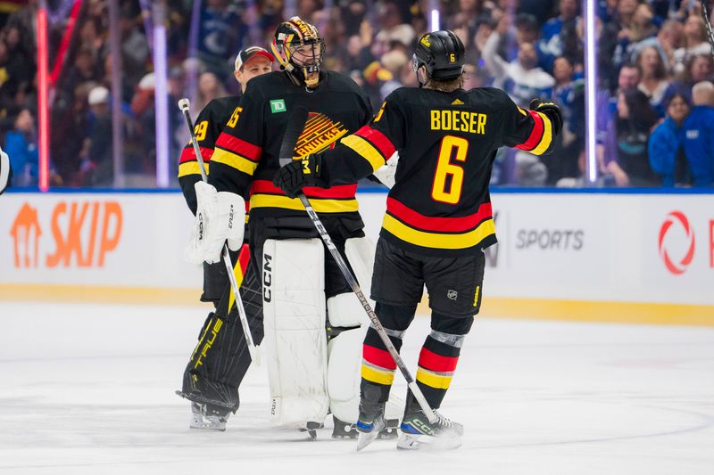 Jan 27, 2024; Vancouver, British Columbia, CAN; Vancouver Canucks goalie Casey DeSmith (29) and goalie Thatcher Demko (35) and forward Brock Boeser (6) celebrate their victory against the Columbus Blue Jackets  at Rogers Arena. Canucks won 5-4 in overtime. Mandatory Credit: Bob Frid-USA TODAY Sports