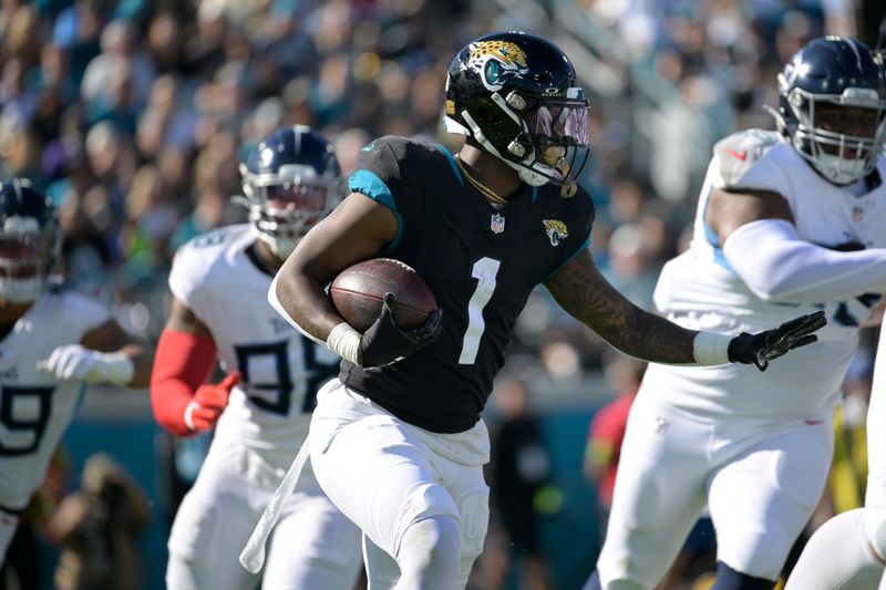 Jacksonville Jaguars running back Travis Etienne Jr. (1) rushes for yardage during the first half of an NFL football game against the Tennessee Titans, Sunday, Nov. 19, 2023, in Jacksonville, Fla. (AP Photo/Phelan M. Ebenhack)