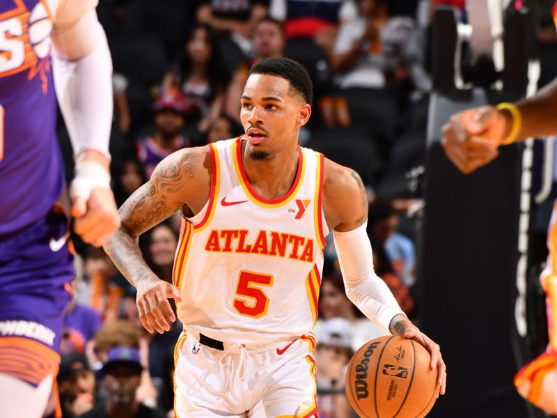 PHOENIX, AZ - MARCH 21:  Dejounte Murray #5 of the Atlanta Hawks handles the ball during the game  on March 21, 2024 at Footprint Center in Phoenix, Arizona. NOTE TO USER: User expressly acknowledges and agrees that, by downloading and or using this photograph, user is consenting to the terms and conditions of the Getty Images License Agreement. Mandatory Copyright Notice: Copyright 2024 NBAE (Photo by Barry Gossage/NBAE via Getty Images)