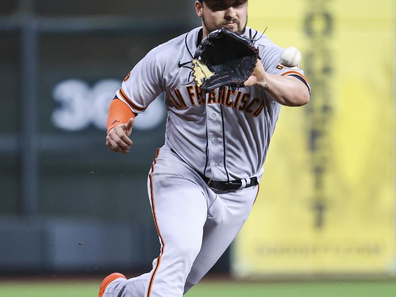 May 1, 2023; Houston, Texas, USA; San Francisco Giants third baseman J.D. Davis (7) fields a ground ball during the second inning against the Houston Astros at Minute Maid Park. Mandatory Credit: Troy Taormina-USA TODAY Sports