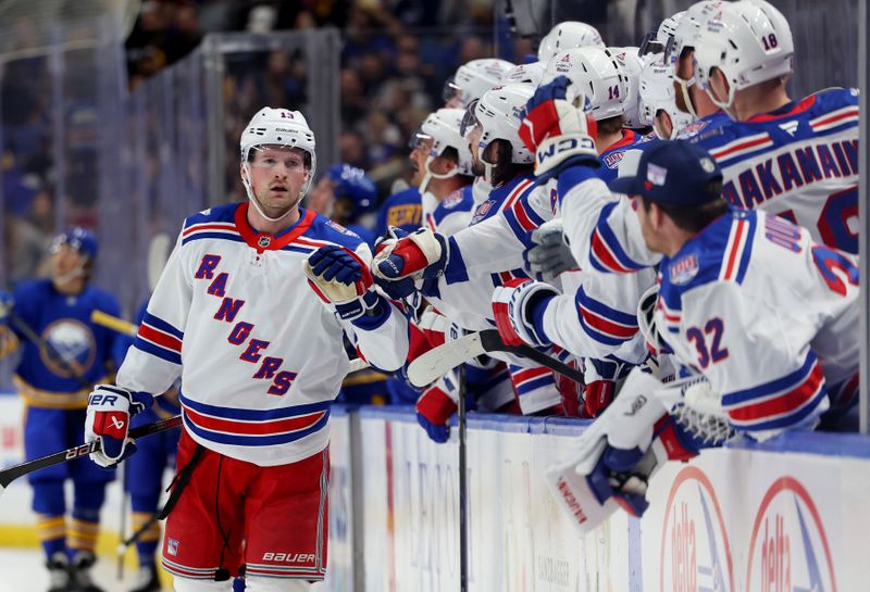 Oct 9, 2025; Buffalo, New York, USA;  New York Rangers left wing Alexis Lafrenière (13) celebrates his goal with teammates during the first period against the Buffalo Sabres at KeyBank Center. Mandatory Credit: Timothy T. Ludwig-Imagn Images