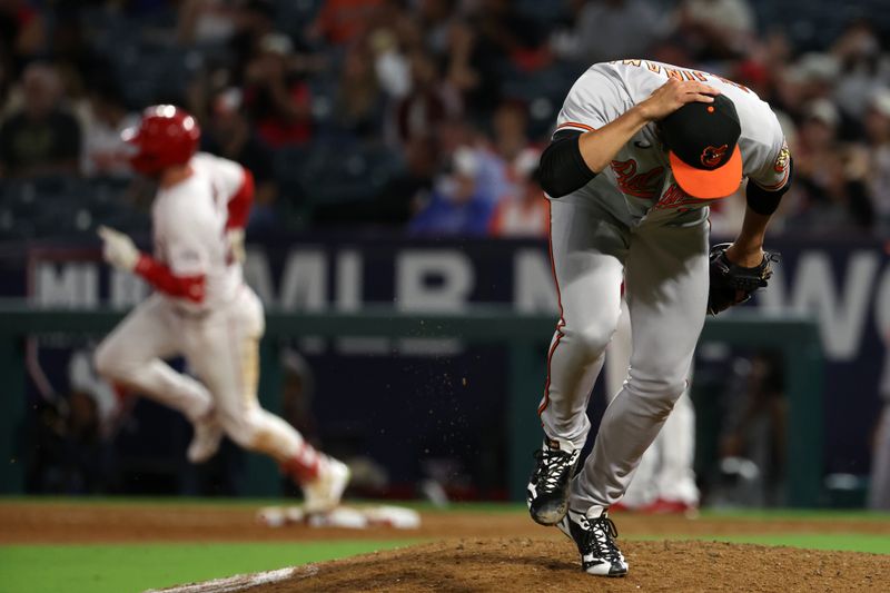 Sep 6, 2023; Anaheim, California, USA; Baltimore Orioles relief pitcher Shintaro Fujinami (14) reacts after giving up a triple to Los Angeles Angels second baseman Brandon Drury (23) during the eighth inning at Angel Stadium. Mandatory Credit: Kiyoshi Mio-USA TODAY Sports