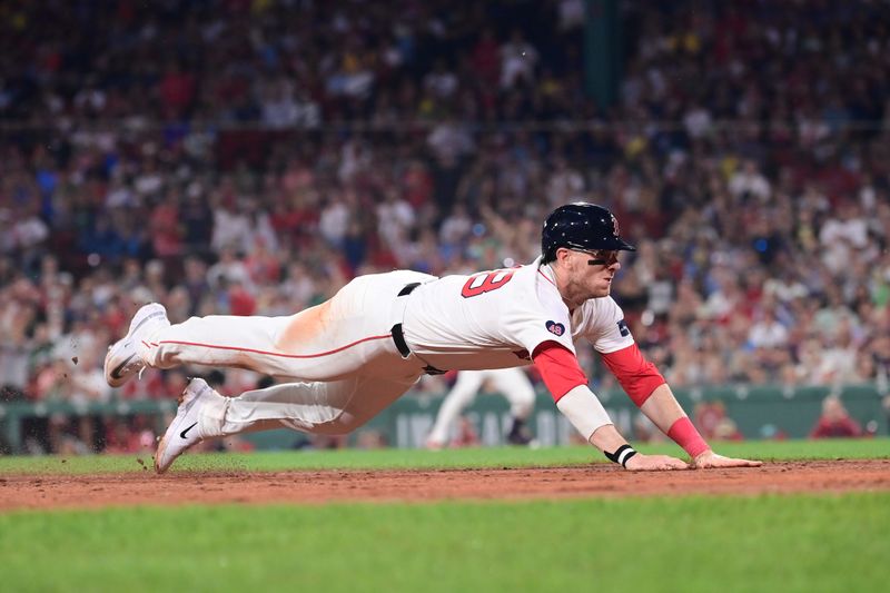 Jul 28, 2024; Boston, Massachusetts, USA; Boston Red Sox designated hitter Danny Jensen (28) dives for third base during the seventh inning against the New York Yankees at Fenway Park. Mandatory Credit: Eric Canha-USA TODAY Sports