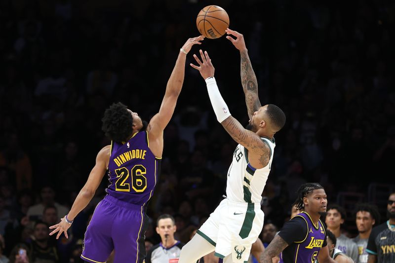 LOS ANGELES, CALIFORNIA - MARCH 08: Spencer Dinwiddie #26 of the Los Angeles Lakers blocks a shot by Damian Lillard #0 of the Milwaukee Bucks during the final seconds of the  second half of a game at Crypto.com Arena on March 08, 2024 in Los Angeles, California. (Photo by Sean M. Haffey/Getty Images)