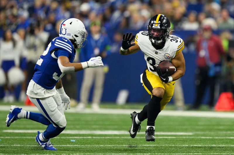 Pittsburgh Steelers running back Jaylen Warren (30) runs to the outside against Indianapolis Colts safety Julian Blackmon (32) during an NFL football game, Saturday, Dec. 16, 2023, in Indianapolis. (AP Photo/Zach Bolinger)