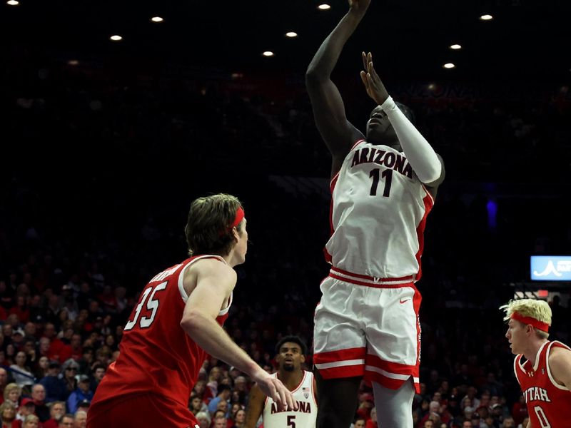 Jan 6, 2024; Tucson, Arizona, USA; Arizona Wildcats center Oumar Ballo (11) shoots a basket against Utah Utes center Branden Carlson (35) during the second half at McKale Center. Mandatory Credit: Zachary BonDurant-USA TODAY Sports