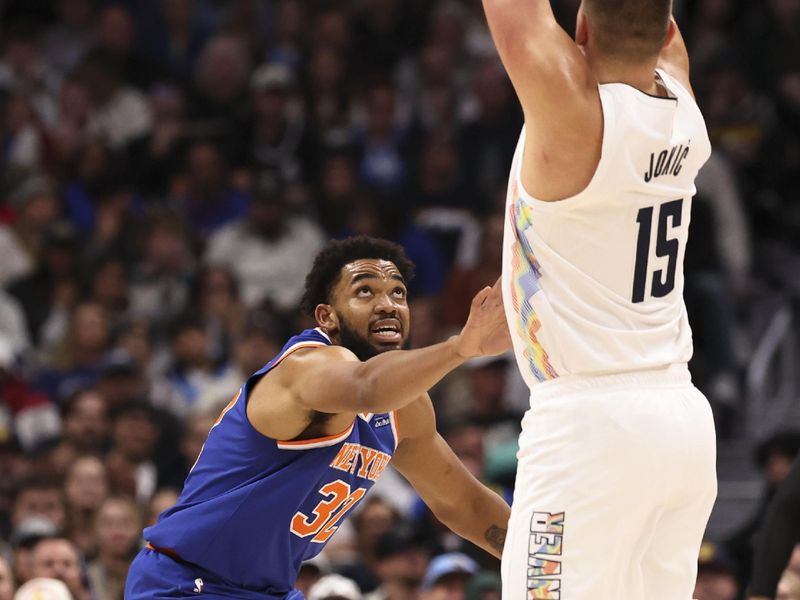 DENVER, COLORADO - NOVEMBER 25: Karl-Anthony Towns #32 of the New York Knicks defends Nikola Jokic #15 of the Denver Nuggets during the first half at Ball Arena on November 25, 2024 in Denver, Colorado. NOTE TO USER: User expressly acknowledges and agrees that, by downloading and/or using this Photograph, user is consenting to the terms and conditions of the Getty Images License Agreement. (Photo by Justin Tafoya/Getty Images)