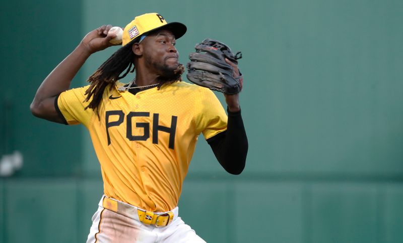 Jul 19, 2024; Pittsburgh, Pennsylvania, USA;  Pittsburgh Pirates shortstop Oneil Cruz (15) throws to first base in an attempt to retire Philadelphia Phillies third base Alec Bohm (not pictured) during the fourth inning at PNC Park. Bohm was safe on the play. Mandatory Credit: Charles LeClaire-USA TODAY Sports