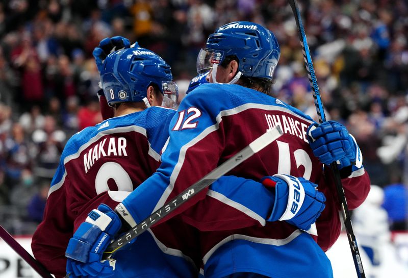 Nov 27, 2023; Denver, Colorado, USA; Colorado Avalanche center Ryan Johansen (12) celebrates his goal with defenseman Cale Makar (8) in the second period against the Tampa Bay Lightning at Ball Arena. Mandatory Credit: Ron Chenoy-USA TODAY Sports