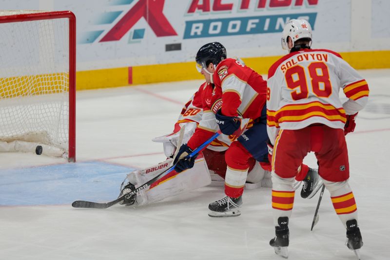 Mar 1, 2025; Sunrise, Florida, USA; Florida Panthers right wing Mackie Samoskevich (25) scores against Calgary Flames goaltender Dan Vladar (80) during the third period at Amerant Bank Arena. Mandatory Credit: Sam Navarro-Imagn Images
