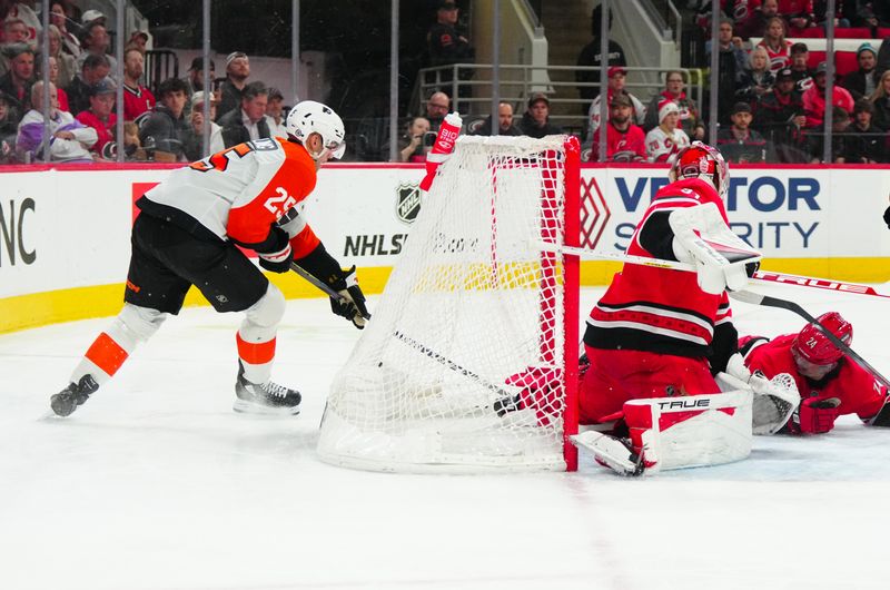 Mar 21, 2024; Raleigh, North Carolina, USA; Philadelphia Flyers center Ryan Poehling (25) is stopped on his scoring attempt by Carolina Hurricanes goaltender Frederik Andersen (31) during the second period at PNC Arena. Mandatory Credit: James Guillory-USA TODAY Sports