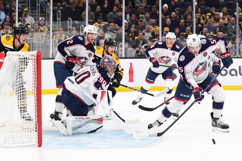 Nov 18, 2024; Boston, Massachusetts, USA;  Columbus Blue Jackets defenseman David Jiricek (55) looks for a rebound in front of goaltender Elvis Merzlikins (90) during the first period against the Boston Bruins at TD Garden. Mandatory Credit: Bob DeChiara-Imagn Images