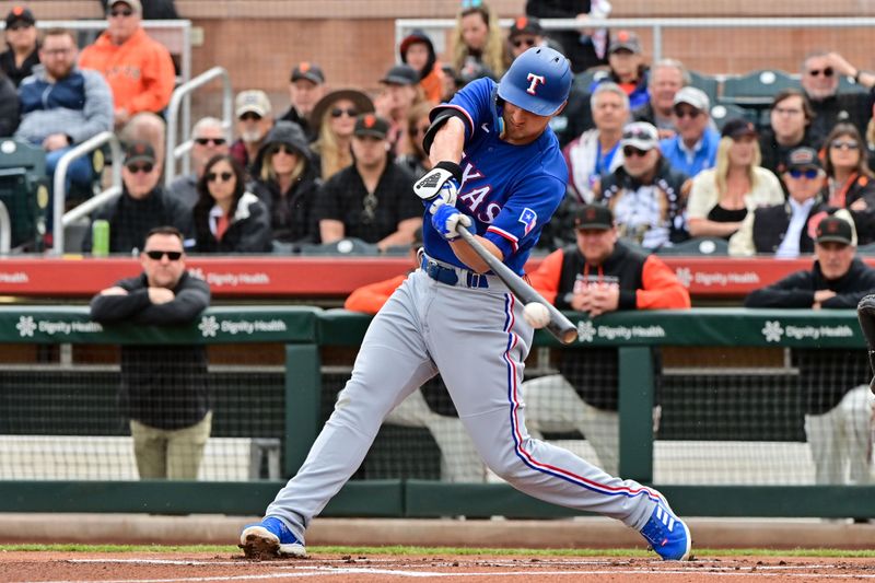 Mar 22, 2023; Scottsdale, Arizona, USA; Texas Rangers shortstop Corey Seager (5) singles in the first inning against the San Francisco Giants during a Spring Training game at Scottsdale Stadium. Mandatory Credit: Matt Kartozian-USA TODAY Sports