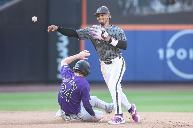 Jul 13, 2024; New York City, New York, USA; New York Mets shortstop Francisco Lindor (12) throws past Colorado Rockies third baseman Ryan McMahon (24) to complete a double play in the eighth inning at Citi Field. Mandatory Credit: Wendell Cruz-USA TODAY Sports