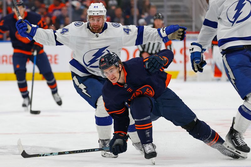 Dec 14, 2023; Edmonton, Alberta, CAN; Tampa Bay Lightning defensemen Calvin de Haan (44) trips up Edmonton Oilers forward Ryan McLeod (71) during the third period at Rogers Place. Mandatory Credit: Perry Nelson-USA TODAY Sports