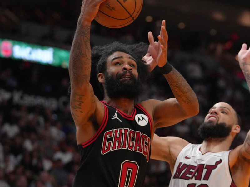 MIAMI, FL - APRIL 19: Coby White #0 of the Chicago Bulls drives to the basket during the game against the Miami Heat during the 2024 SoFi Play-In Tournament on April 19, 2024 at Kaseya Center in Miami, Florida. NOTE TO USER: User expressly acknowledges and agrees that, by downloading and or using this Photograph, user is consenting to the terms and conditions of the Getty Images License Agreement. Mandatory Copyright Notice: Copyright 2024 NBAE (Photo by Eric Espada/NBAE via Getty Images)