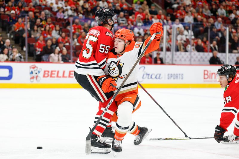 Oct 19, 2025; Chicago, Illinois, USA; Chicago Blackhawks defenseman Artyom Levshunov (55) defends against Anaheim Ducks right wing Beckett Sennecke (45) during the first period at United Center. Mandatory Credit: Kamil Krzaczynski-Imagn Images