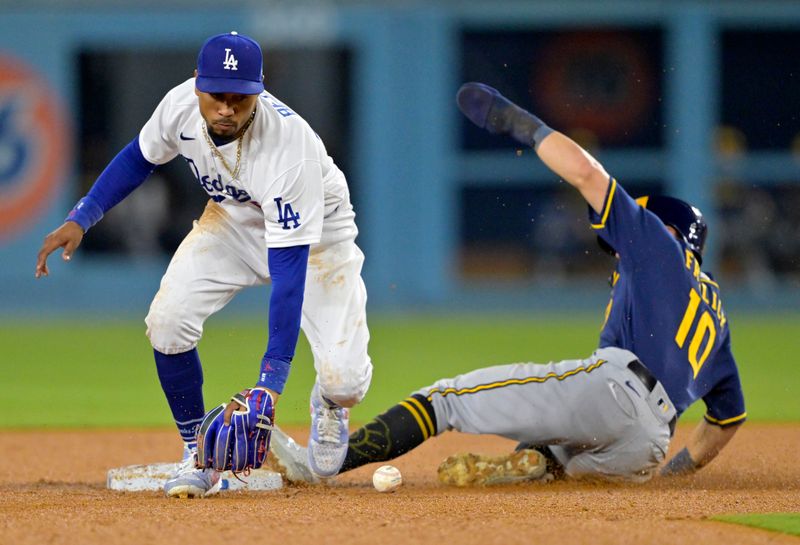 Aug 17, 2023; Los Angeles, California, USA;  Los Angeles Dodgers right fielder Mookie Betts (50) reaches for the ball as Milwaukee Brewers outfielder Sal Frelick (10) steals second in the fourth inning at Dodger Stadium. Mandatory Credit: Jayne Kamin-Oncea-USA TODAY Sports