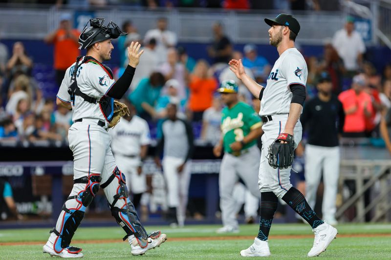 Jun 4, 2023; Miami, Florida, USA; Miami Marlins relief pitcher Dylan Floro (36) celebrates with catcher Nick Fortes (4) after winning the game against the Oakland Athletics at loanDepot Park. Mandatory Credit: Sam Navarro-USA TODAY Sports