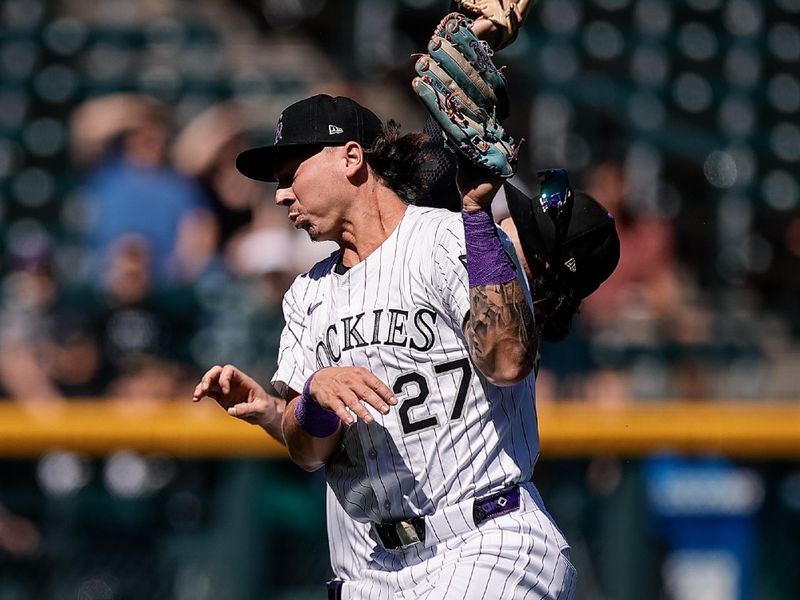 Sep 18, 2025; Denver, Colorado, USA; Colorado Rockies left fielder Jordan Beck (27) avoids a collision with third baseman Kyle Karros (12) on a play in the first inning against the Miami Marlins at Coors Field. Mandatory Credit: Isaiah J. Downing-Imagn Images