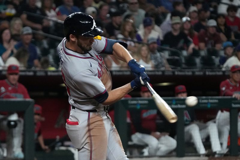 Apr 25, 2025; Phoenix, Arizona, USA; Atlanta Braves outfielder Eli White (36) hits an RBI single against the Arizona Diamondbacks in the eighth inning at Chase Field. Mandatory Credit: Rick Scuteri-Imagn Images