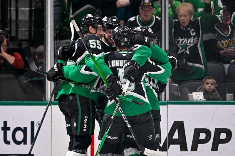 Jan 18, 2026; Dallas, Texas, USA; Dallas Stars center Oskar Beck (10) and defenseman Thomas Harley (55) and defenseman Nils Lundkvist (5) and center Mavrik Bourque (22) celebrates after Beck scores a goal against the Tampa Bay Lightning during the first period at the American Airlines Center. Mandatory Credit: Jerome Miron-Imagn Images