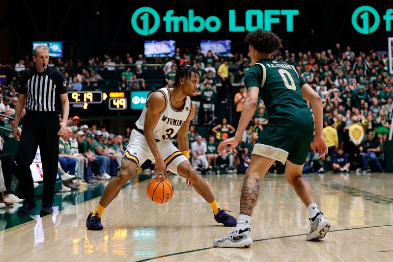 Mar 2, 2024; Fort Collins, Colorado, USA; Wyoming Cowboys guard Sam Griffin (3) controls the ball as Colorado State Rams guard Kyan Evans (0) guards in the second half at Moby Arena. Mandatory Credit: Isaiah J. Downing-USA TODAY Sports