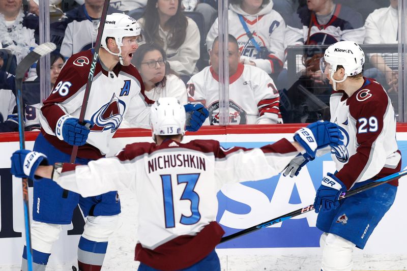 Apr 30, 2024; Winnipeg, Manitoba, CAN; Colorado Avalanche right wing Mikko Rantanen (96) celebrates his third period goal with Colorado Avalanche right wing Valeri Nichushkin (13) and Colorado Avalanche center Nathan MacKinnon (29) against the Winnipeg Jets in game five of the first round of the 2024 Stanley Cup Playoffs at Canada Life Centre. Mandatory Credit: James Carey Lauder-USA TODAY Sports