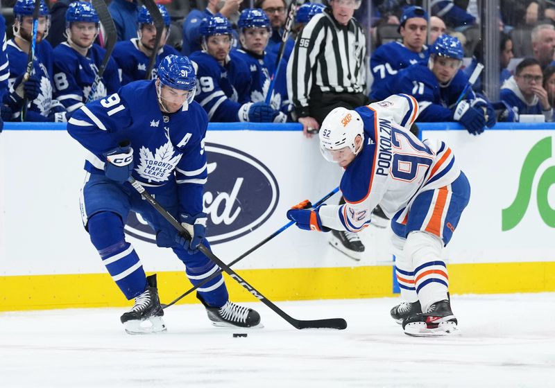 Dec 13, 2025; Toronto, Ontario, CAN; Toronto Maple Leafs center John Tavares (91) battles for the puck with Edmonton Oilers right wing Vasily Podkolzin (92) during the second period at Scotiabank Arena. Mandatory Credit: Nick Turchiaro-Imagn Images