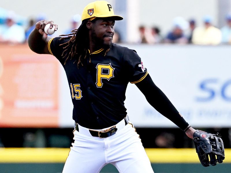 Mar 25, 2024; Bradenton, Florida, USA; Pittsburgh Pirates shortstop Oniel Cruz (15) throws to first base in the first inning of the spring training game against the Toronto Blue Jays at LECOM Park. Mandatory Credit: Jonathan Dyer-USA TODAY Sports