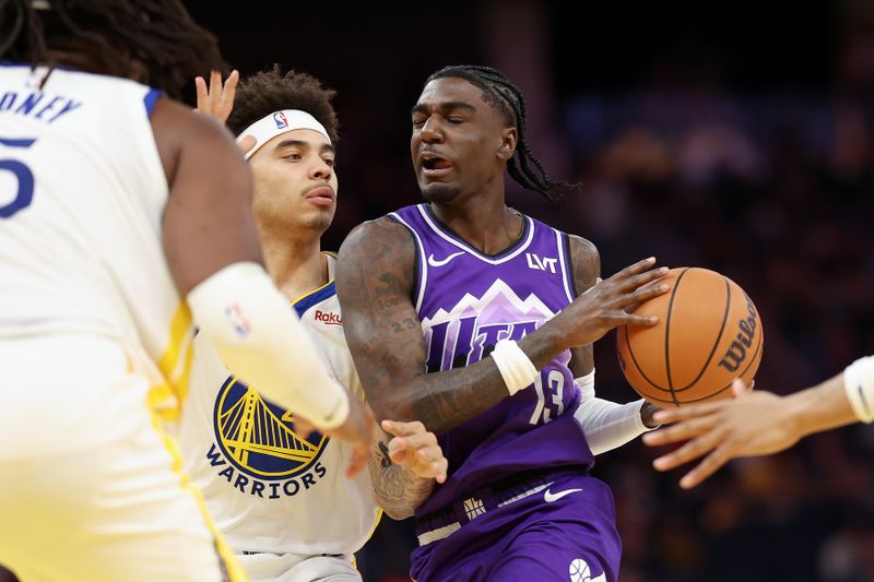 SAN FRANCISCO, CALIFORNIA - APRIL 14: Kira Lewis Jr. #13 of the Utah Jazz is guarded by Lester Quinones #25 of the Golden State Warriors in the second half at Chase Center on April 14, 2024 in San Francisco, California. NOTE TO USER: User expressly acknowledges and agrees that, by downloading and or using this photograph, User is consenting to the terms and conditions of the Getty Images License Agreement.  (Photo by Ezra Shaw/Getty Images)