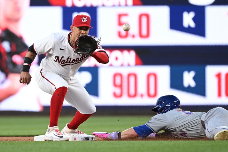 Jul 1, 2024; Washington, District of Columbia, USA; Washington Nationals second baseman Ildemaro Vargas (14) catches the ball at second base in front of New York Mets center fielder Harrison Bader (44) during the sixth inning at Nationals Park. Mandatory Credit: Rafael Suanes-USA TODAY Sports