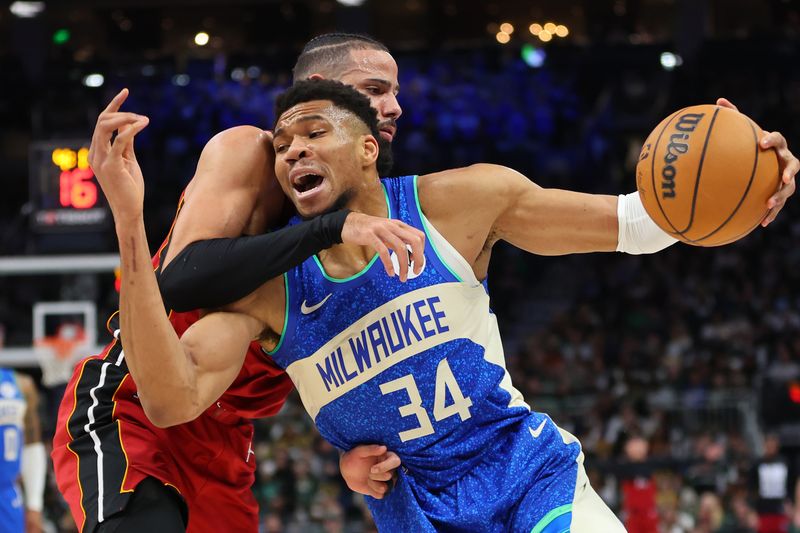 MILWAUKEE, WISCONSIN - FEBRUARY 13: Giannis Antetokounmpo #34 of the Milwaukee Bucks is fouled by Caleb Martin #16 of the Miami Heat during the first half of a game at Fiserv Forum on February 13, 2024 in Milwaukee, Wisconsin. NOTE TO USER: User expressly acknowledges and agrees that, by downloading and or using this photograph, User is consenting to the terms and conditions of the Getty Images License Agreement. (Photo by Stacy Revere/Getty Images)