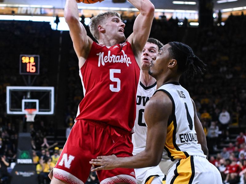 Mar 5, 2023; Iowa City, Iowa, USA; Nebraska Cornhuskers guard Sam Griesel (5) is defended by Iowa Hawkeyes guard Ahron Ulis (1) and forward Filip Rebraca (0) during the first half at Carver-Hawkeye Arena. Mandatory Credit: Jeffrey Becker-USA TODAY Sports