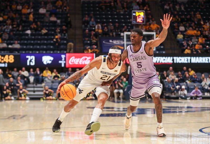 Jan 9, 2024; Morgantown, West Virginia, USA; West Virginia Mountaineers guard RaeQuan Battle (21) drives against Kansas State Wildcats guard Cam Carter (5) during the second half at WVU Coliseum. Mandatory Credit: Ben Queen-USA TODAY Sports