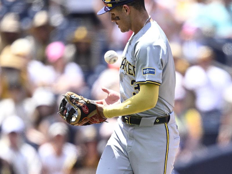 Jun 23, 2024; San Diego, California, USA; Milwaukee Brewers third baseman Joey Ortiz (3) bobbles a ball during the fourth inning against the San Diego Padres at Petco Park. Ortiz was charged with an error on the play. Mandatory Credit: Orlando Ramirez-USA TODAY Sports