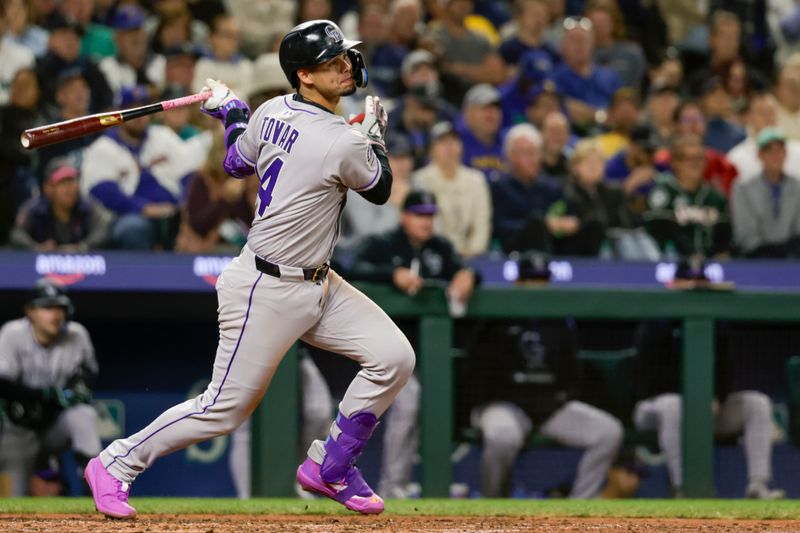 Sep 25, 2025; Seattle, Washington, USA; Colorado Rockies shortstop Ezequiel Tovar (14) hits an RBI-single against the Seattle Mariners during the sixth inning at T-Mobile Park. Mandatory Credit: Joe Nicholson-Imagn Images
