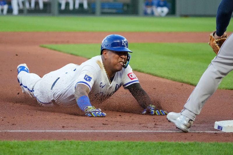 Apr 9, 2024; Kansas City, Missouri, USA; Kansas City Royals catcher Salvador Perez (13) slides into third base against the Houston Astros in the third inning at Kauffman Stadium. Mandatory Credit: Denny Medley-USA TODAY Sports