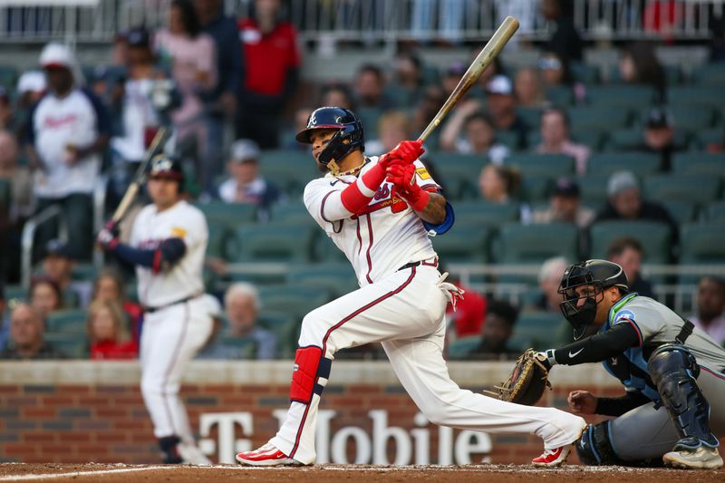 Apr 22, 2024; Atlanta, Georgia, USA; Atlanta Braves shortstop Orlando Arcia (11) hits a single against the Miami Marlins in the first inning at Truist Park. Mandatory Credit: Brett Davis-USA TODAY Sports