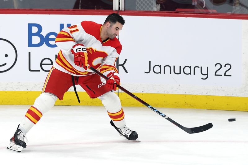 Jan 18, 2025; Winnipeg, Manitoba, CAN; Calgary Flames center Nazem Kadri (91) warms up before a game against the Winnipeg Jets at Canada Life Centre. Mandatory Credit: James Carey Lauder-Imagn Images