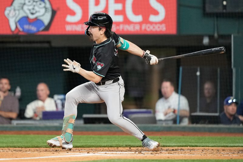 May 29, 2024; Arlington, Texas, USA; Arizona Diamondbacks center fielder Corbin Carroll (7) follows through on his double against the Texas Rangers during the third inning at Globe Life Field. Mandatory Credit: Jim Cowsert-USA TODAY Sports