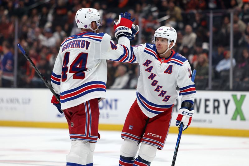 Jan 19, 2026; Anaheim, California, USA;  New York Rangers defenseman Vladislav Gavrikov (44) is greeted by left wing Artemi Panarin (10) after scoring a goal during the third period at Honda Center. Mandatory Credit: Kiyoshi Mio-Imagn Images