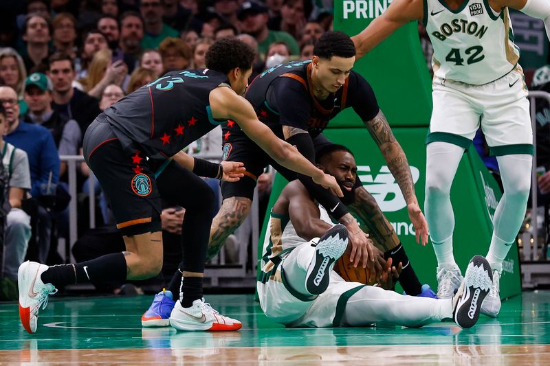 BOSTON, MA - FEBRUARY 09: Jaylen Brown #7 of the Boston Celtics tries to keep the ball from Jordan Poole #13 of the Washington Wizards and Kyle Kuzma #33 during the second half at TD Garden on February 9, 2024 in Boston, Massachusetts. NOTE TO USER: User expressly acknowledges and agrees that, by downloading and/or using this Photograph, user is consenting to the terms and conditions of the Getty Images License Agreement. (Photo By Winslow Townson/Getty Images)