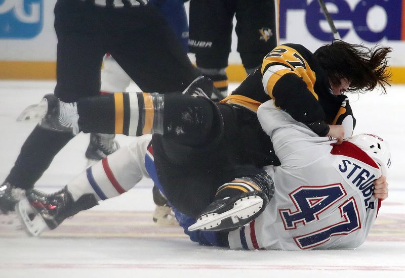 Nov 2, 2024; Pittsburgh, Pennsylvania, USA;  Pittsburgh Penguins defenseman Ryan Graves (27) and Montreal Canadiens defenseman Jayden Struble (47) fight as time expires during the third period at PPG Paints Arena. Mandatory Credit: Charles LeClaire-Imagn Images